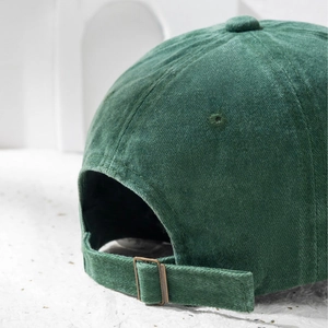 Dark green corduroy baseball cap with adjustable metal buckle and vintage textured fabric