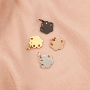 Set of four stainless steel pet paw pendants with crystals in gold, silver, and black