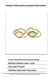 Detail of 18k gold plated stainless steel rings featuring clear and green resin inlays