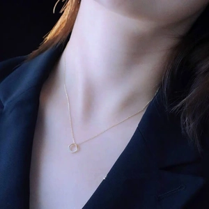 Detail of 14k gold plated S925 silver necklace with sparkling zircon round pendant