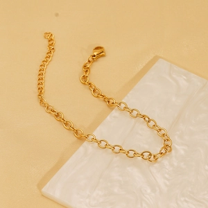 Classic gold stainless steel O-link bracelet with lobster clasp on silk and marble