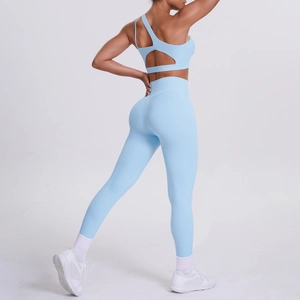 Detail of light blue one-shoulder sports bra and high-waist yoga pants with cutout back
