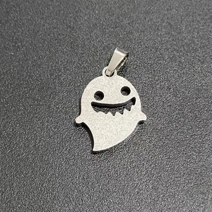 Close-up of polished silver stainless steel ghost pendant for Halloween necklace