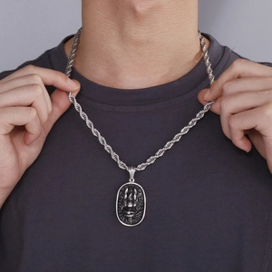 Detailed view of silver dragon relief pendant and twisted rope chain for men