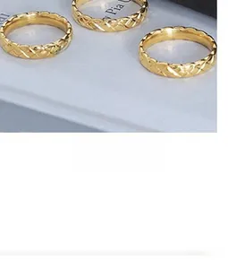 Close-up of gold rings featuring classic matelassé quilted texture and polished finish