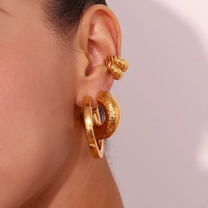 Close-up of chunky 18K gold plated hoop earrings and textured ear cuff on model