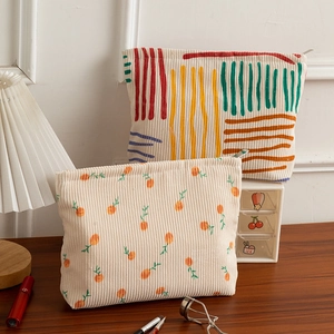 Detailed close-up of corduroy floral makeup bags with high-quality metal zipper