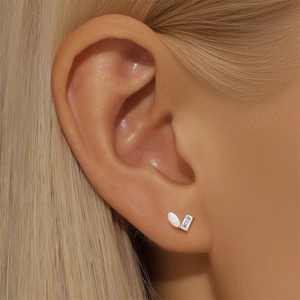 Detail of S925 silver ear stud with marquise opal and zircon on model ear