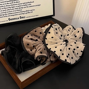 Polka dot oversized scrunchies set in neutral tones on a wooden tray with pearls