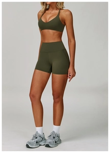 Detail of high-waist seamless olive green yoga shorts with wide support waistband