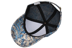 Detail of blue and gold jacquard baseball cap with adjustable bronze buckle and mesh