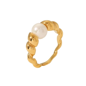 Golden stainless steel twisted ring with a round white pearl on a clean white background