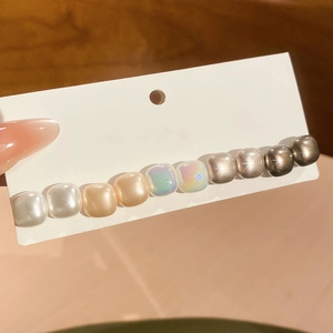 Close-up of colorful resin beads hair clip on a display card for minimalist styling