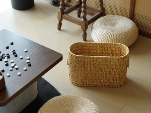 Detailed texture of handcrafted woven seagrass storage basket in a zen home setting