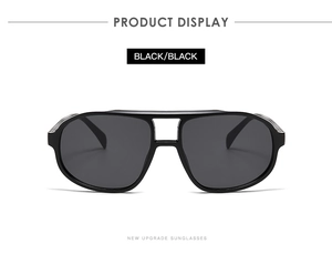Front view of black pilot sunglasses with wide frame and integrated nose pads on white background