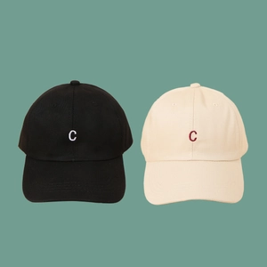 Classic baseball caps in black and beige featuring embroidered letter C on a flat background