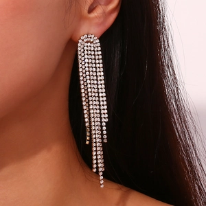 Detail of silver long tassel earrings with micro-inlaid white zircons for evening wear