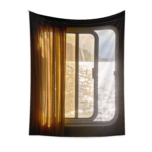 Close-up of vintage landscape wall tapestry with yellow curtains and water view