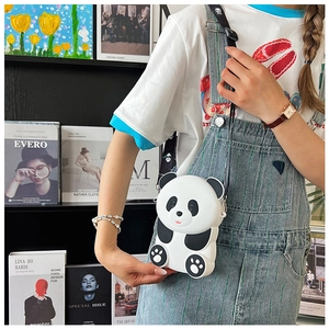 Detailed view of a cute panda silicone crossbody bag worn by a child in a home setting