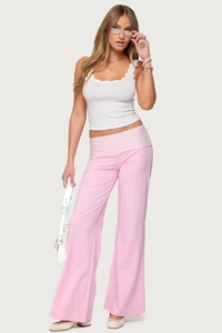 Detail of pink flare pants with unique pink and white striped fold-over waist design