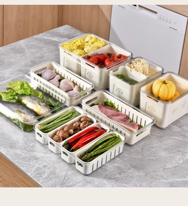 Detail showing PET storage bins with drainage baskets on a kitchen marble countertop