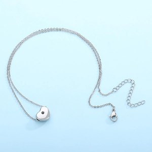 Minimalist silver stainless steel heart necklace with a tiny black gemstone pendant