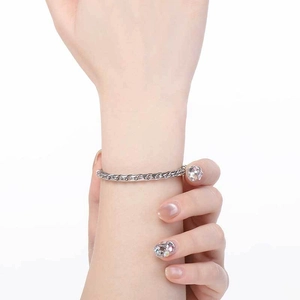 Detailed view of a silver twisted keel chain bracelet with round clasp on model wrist