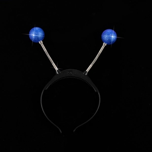 Close-up of glowing alien headband with blue glitter balls and silver springs for party