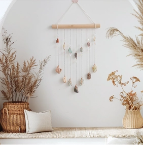 Detail of bohemian natural crystal stone dream catcher hanging from a rustic wooden stick