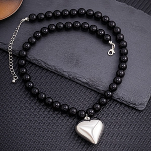 Black beaded necklace for men featuring a metallic silver heart pendant on slate base