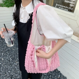 Detail of pink bubble texture shoulder bag with textured puffy fabric in street style