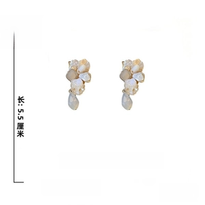 Detail of floral earrings with pearls, crystals and size dimensions of 5.5cm by 2.7cm