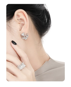 Detail showing elegant silver ginkgo leaf earrings and ring set with sparkling zircon pavé