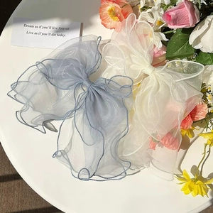 Elegant large organza bow hair clips in white and blue with wavy edges for women