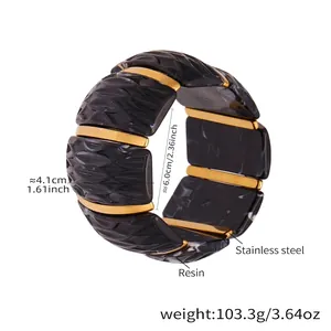 Detail view of 4.1cm wide elastic resin bracelet with gold stainless steel texture