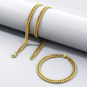 Close-up of golden stainless steel Cuban chain necklace and bracelet jewelry set