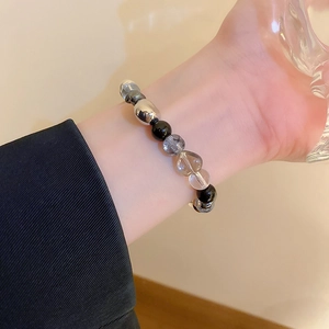 Minimalist black gallstone and crystal beaded bracelet shown on a woman's wrist
