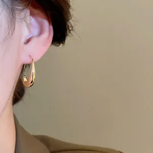 Elegant 14k gold plated geometric oval hoop earrings with a polished mirror finish