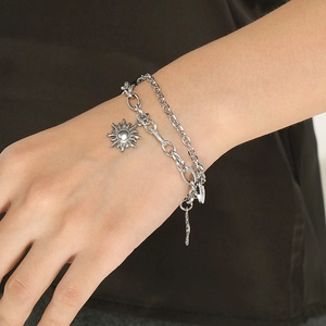 Double-layered stainless steel silver sun pendant bracelet for women on model wrist