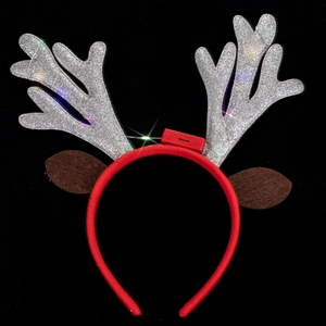 Detail of glowing LED reindeer antlers headband with glitter texture and red lights