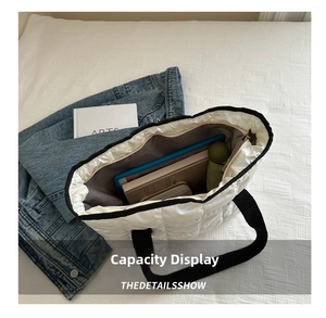 Detailed internal view of white quilted tote bag showing spacious capacity and pocket