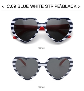 Close-up of heart-shaped sunglasses with blue and white stripes and black lenses