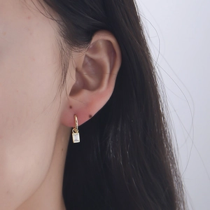 925 silver geometric square zircon gold drop earrings worn by a model in profile view