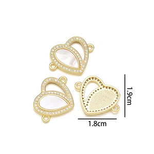Detail view of heart-shaped gold pendant with shell inlay and diamonds showing 1.9cm size