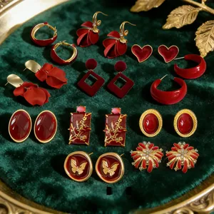 Macro shot of vintage red floral and heart earrings on a green velvet display