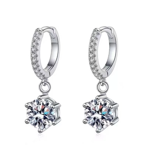 Close-up of silver hoop earrings featuring a six-prong set round zircon stone drop