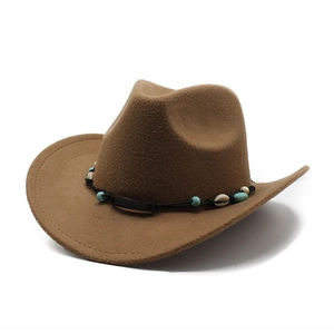 Detail of brown felt cowboy hat featuring black woven band with turquoise beads and shells