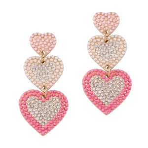 Vintage gold heart earrings with rhinestones and pink pearls on a white background