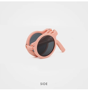 Folded pink round kids sunglasses showing compact design and portable hinge structure