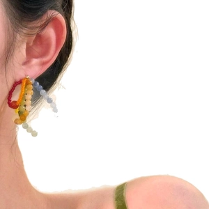 Rainbow beaded earrings with colorful small round beads on a model for summer vacation style